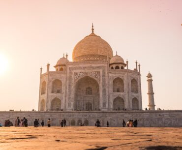 Sunrise view of the Taj Mahal with golden light reflecting on white marble during 2-week India tour.