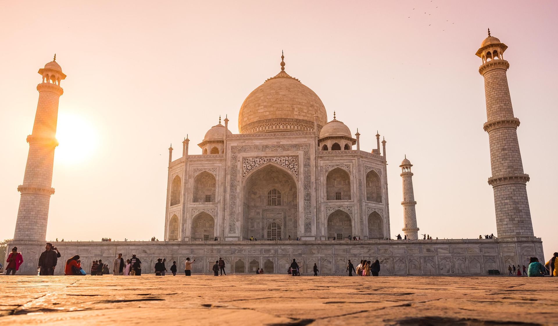 Sunrise view of the Taj Mahal with golden light reflecting on white marble during 2-week India tour.